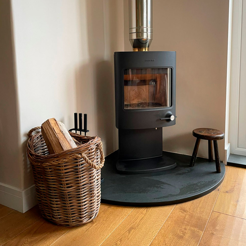 A Quater of a Circle Shaped Fire Hearth with a Fuel Burner Basket and Stool