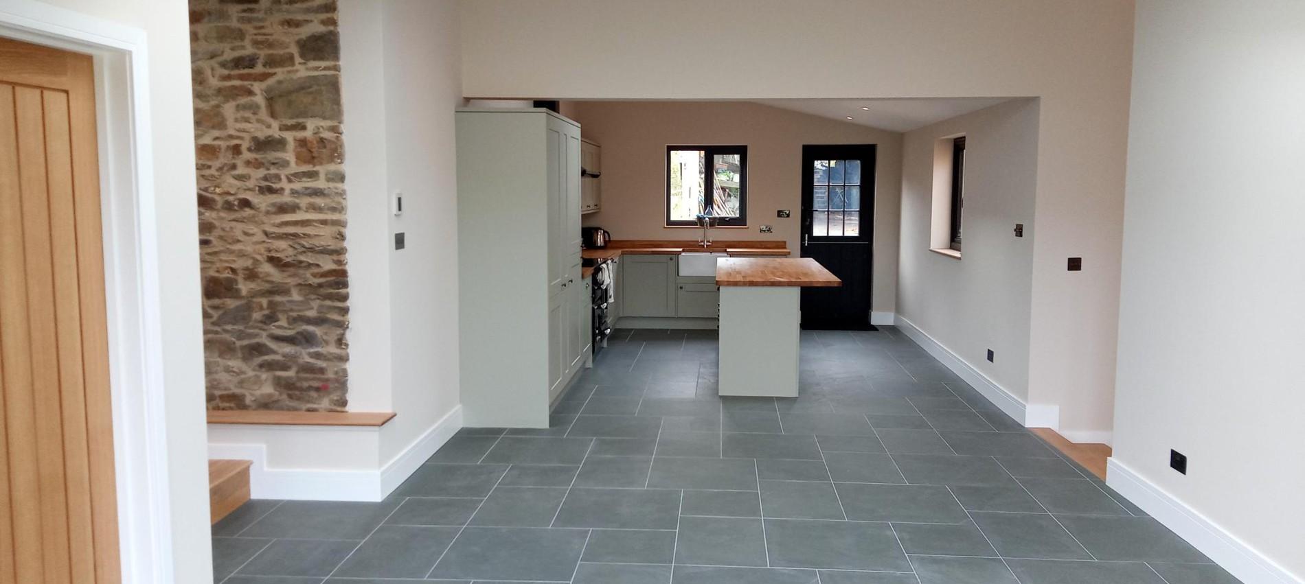 Blue grey slate floor tiles in open plan kitchen.