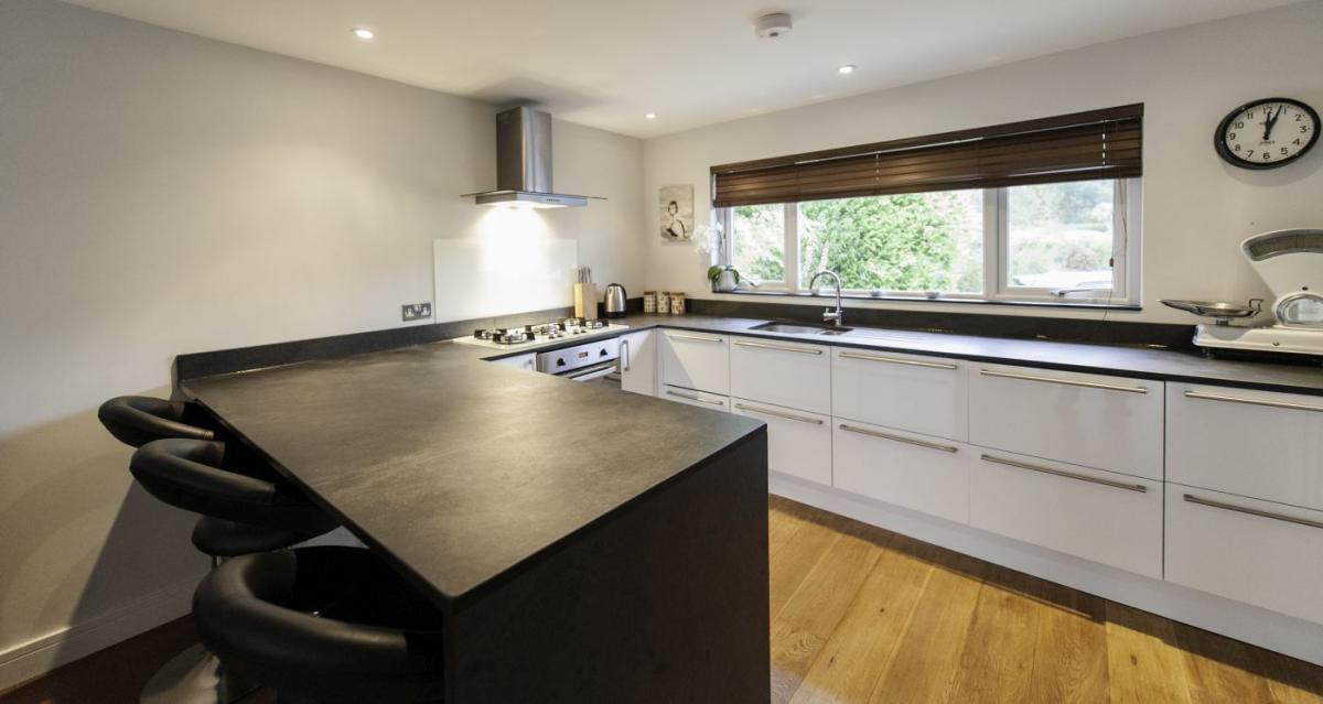 custom built kitchen with breakfast table with slate top
