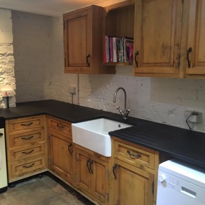 Cottage kitchen with Belfast sink and draining board and aga oven