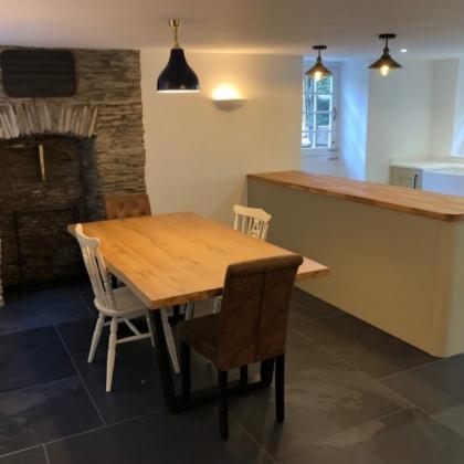 dining and kitchen area with slate slab flooring
