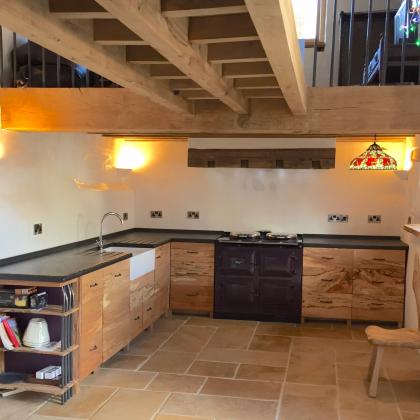 New barn conversion contemporary kitchen with natural wood and slate kitchen tops