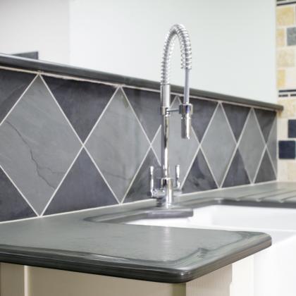 Classic u shaped tap and Belfast sink surrounds in slate with smooth edging