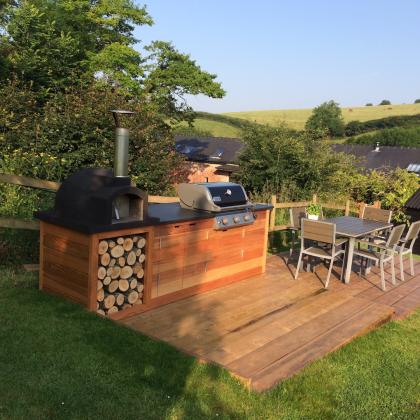 Custom built bbq with slate countertop in country garden