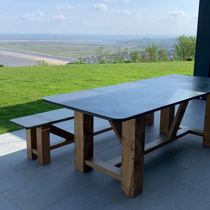 slate table and bench with a stunning view over the sea