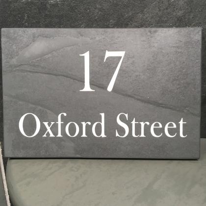 Engraved sign for house number and street name