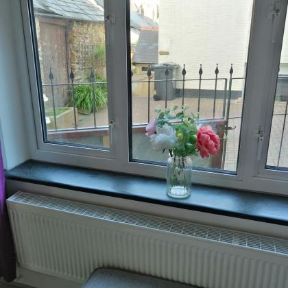 Aged slate on a new window sill overlloking a garden