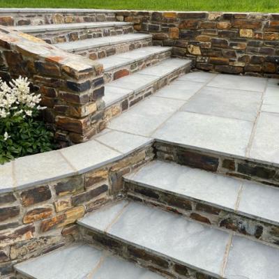 lime ash ashlar limestone steps in a garden with a patio and natural stone