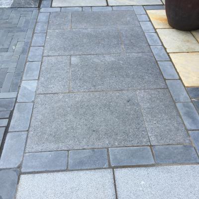 Polished slate paving in dark grey for a patio
