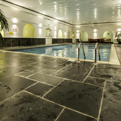 swimming pool with slate protective skirting around the edges