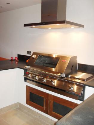 Worktop for a commercial kitchen in slate with double cooker and fan overhead