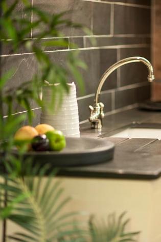 Kitchen wall tiles in slate above a Belfast sink and slate sink top