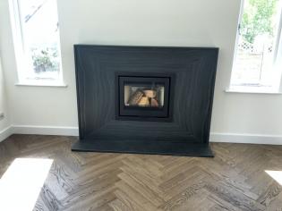 hand polished slate fire surround with parquet flooring