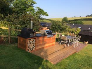 Out door custom built bbq and pizza oven made from wood with a slate top