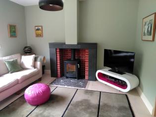 Fire in a modern cottage lounge with a marble hearth