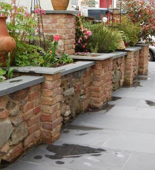slate wall coping from Ardosia on a brick and natural stone garden wall