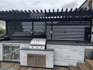 outdoor built in bbq and bar with slate worktop with fridge