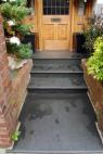 Front path and Steps in Black Slate with red brick sides