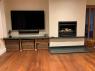 modern family lounge with tv, woodburner and slate hearth below inset fire