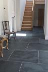 Traditional rectangular slate floor tiles in graphite black in a hallway