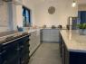 kitchen with blue grey slate floor, contrasting coloured units and breakfast island