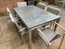 Outdoor modern table with a slate table top that seats six people