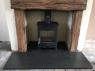 black slate hearth with a woodburner from Ardosia in an old inglenook
