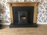 Wooden surround about a traditional 19th century Victorian fireplace with raised hearth